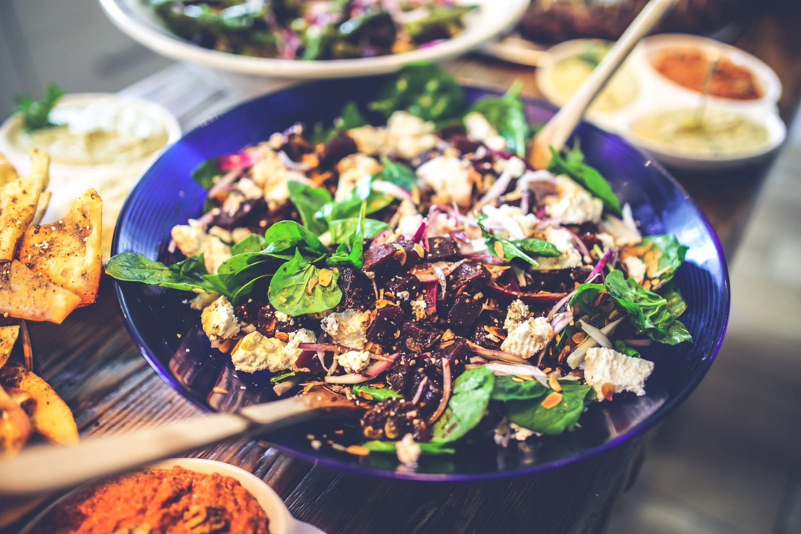 A colorful plate of leafy greens, beets, and fresh vegetables, representing the foods with the strongest evidence for supporting healthy blood pressure