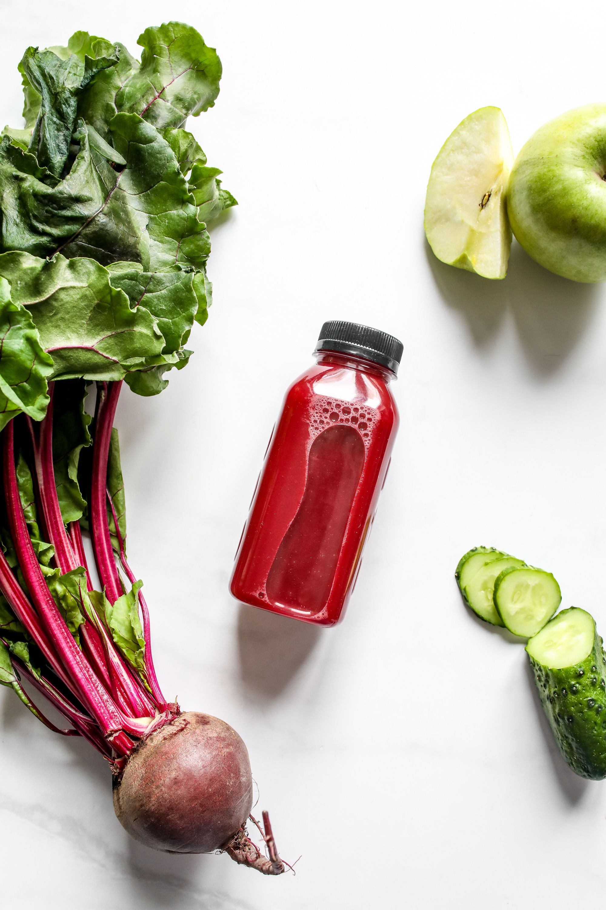 Fresh beetroot, apple, and cucumber beside a bottle of beetroot juice, representing the ingredients with real research behind blood pressure support