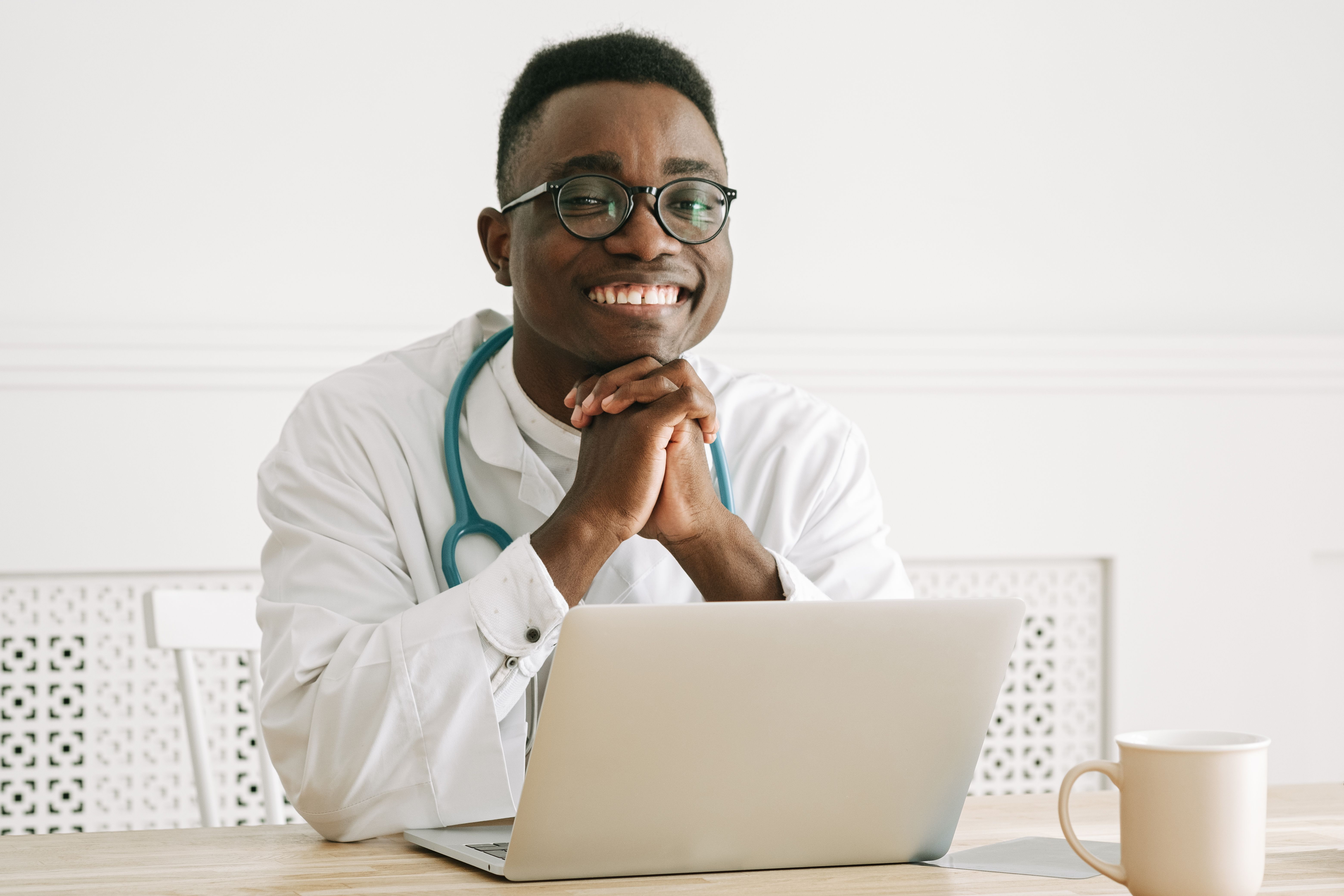 A smiling doctor with a stethoscope ready to discuss blood pressure medication with a patient